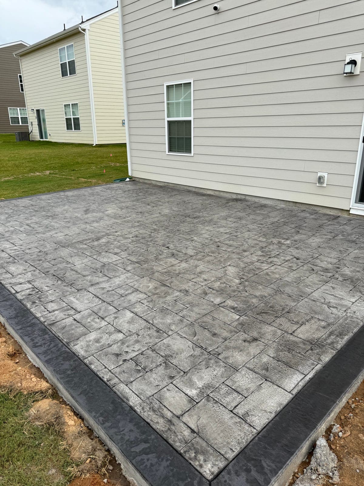 Stamped concrete installation in Cary, NC — decorative pattern, integral color, textured finish by Local Concrete Contractor.