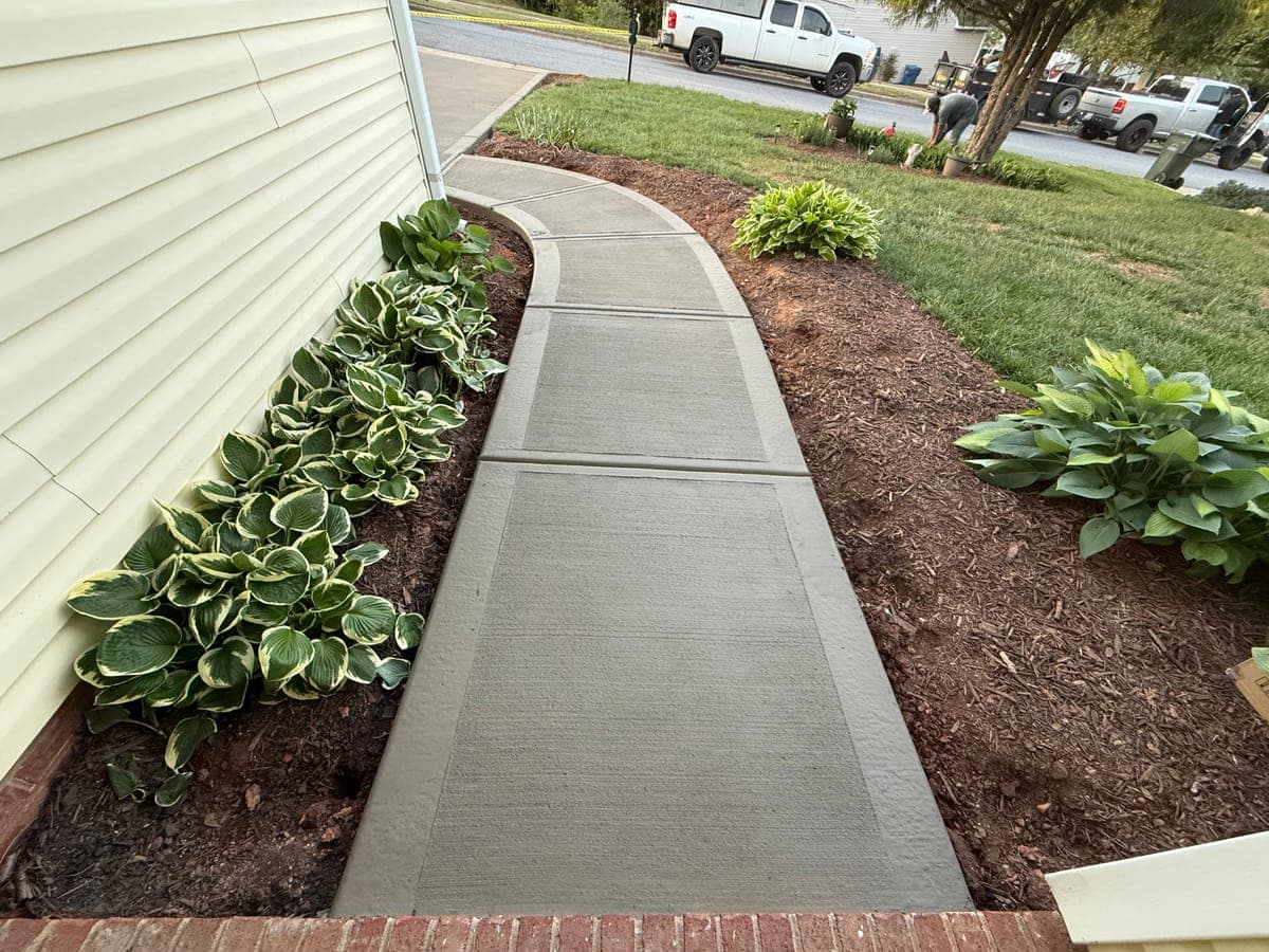 Concrete sidewalk installation in Knightdale, NC — poured pathway, saw-cut control joints, broom-finish surface by Local Concrete Contractor.