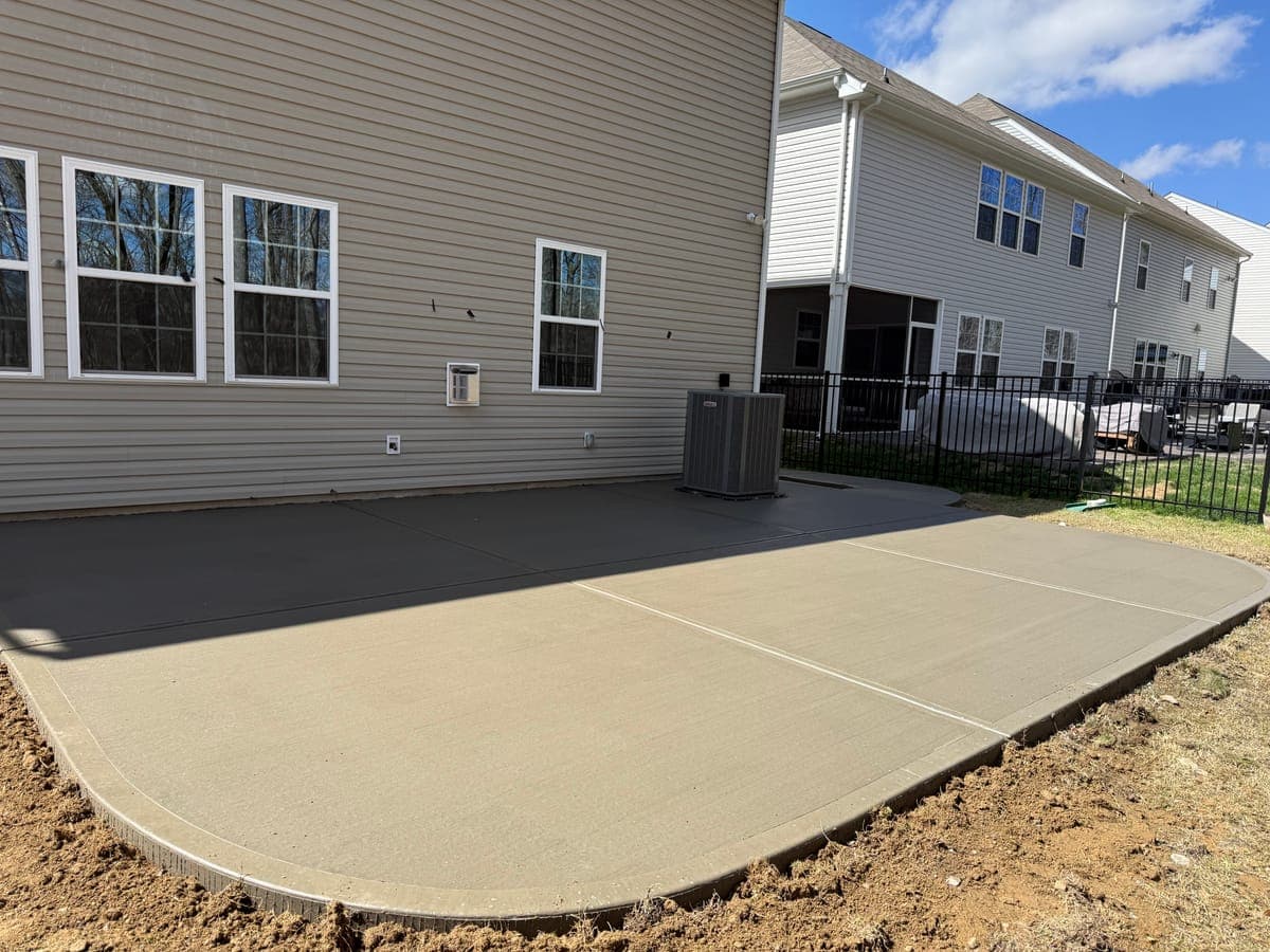 Concrete patio addition in Monroe, NC — bump-out or wrap-around tied to existing slab by Local Concrete Contractor.